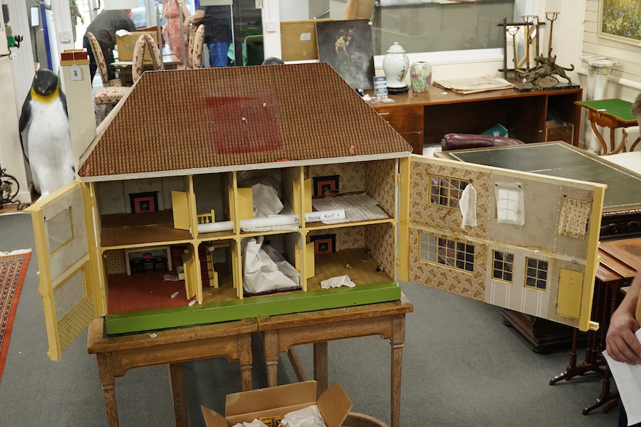 A modern ‘Vine House’ dolls house with furniture and accessories; a large six room house with hall and stairwell, the front wall opening in two sections on hinges each side, with internal decoration and lighting, width 1
